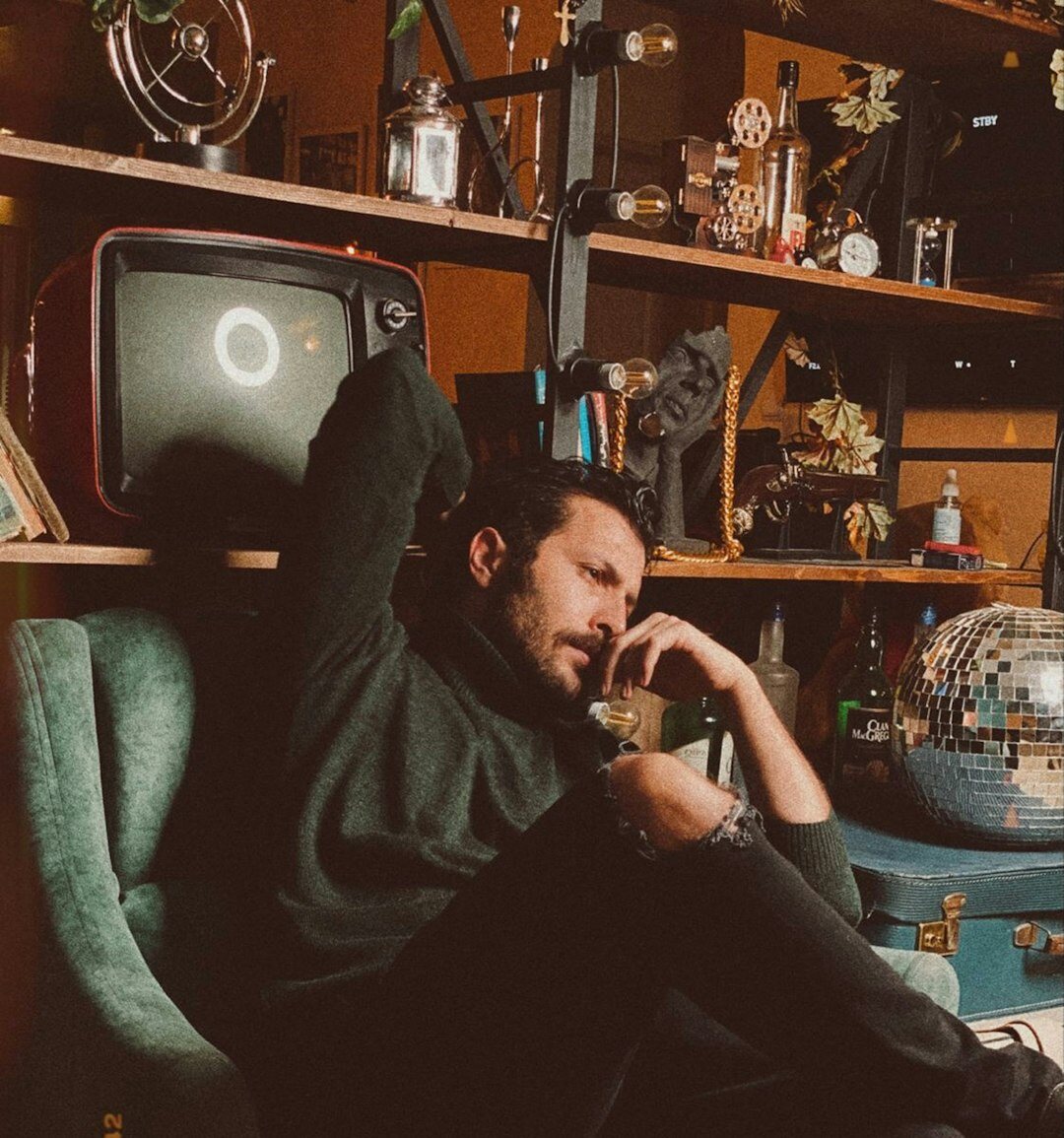 Founder of a podcast studio sitting at a desk with headphones