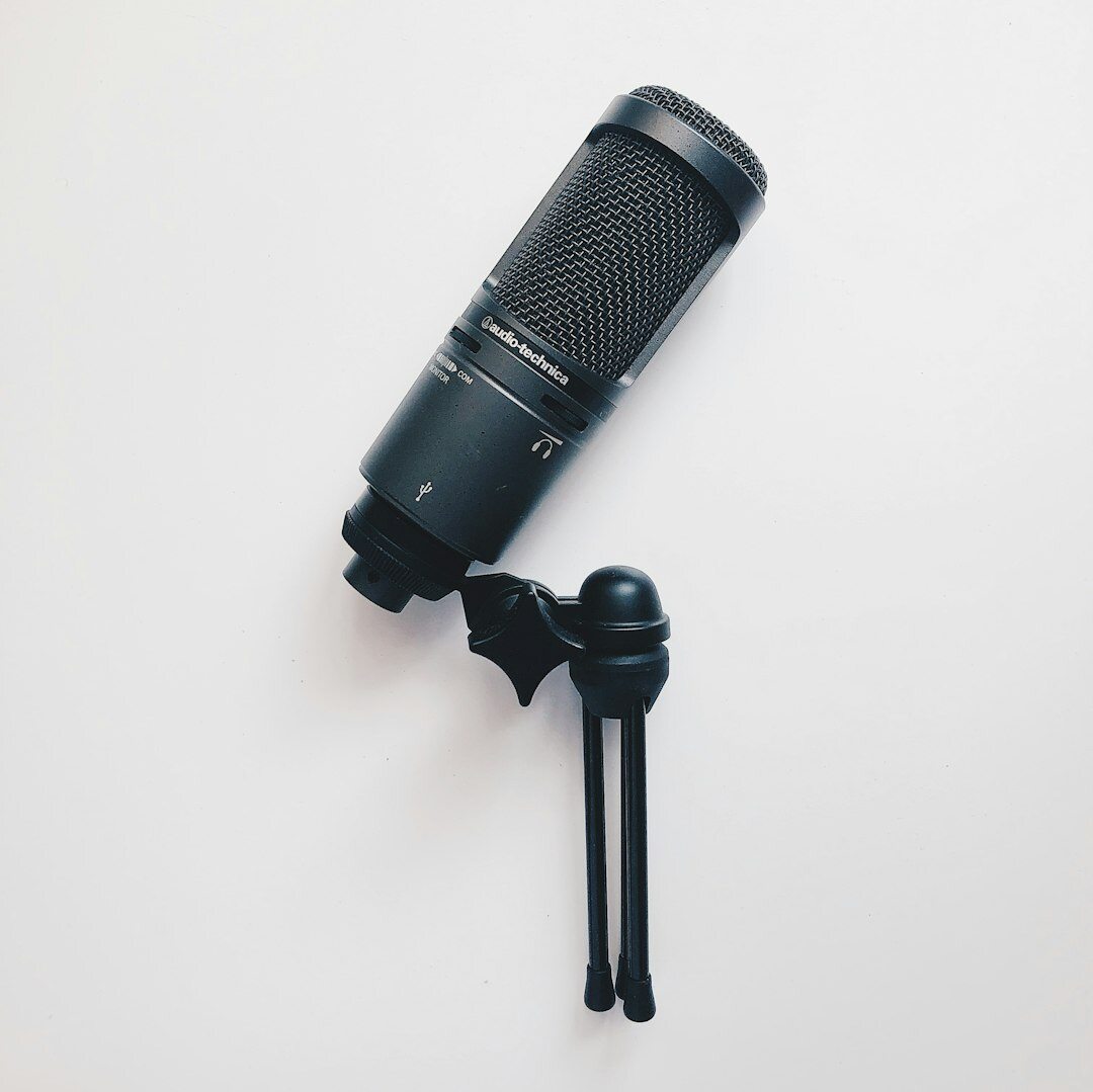 Professional podcast microphone with pop filter on a desk