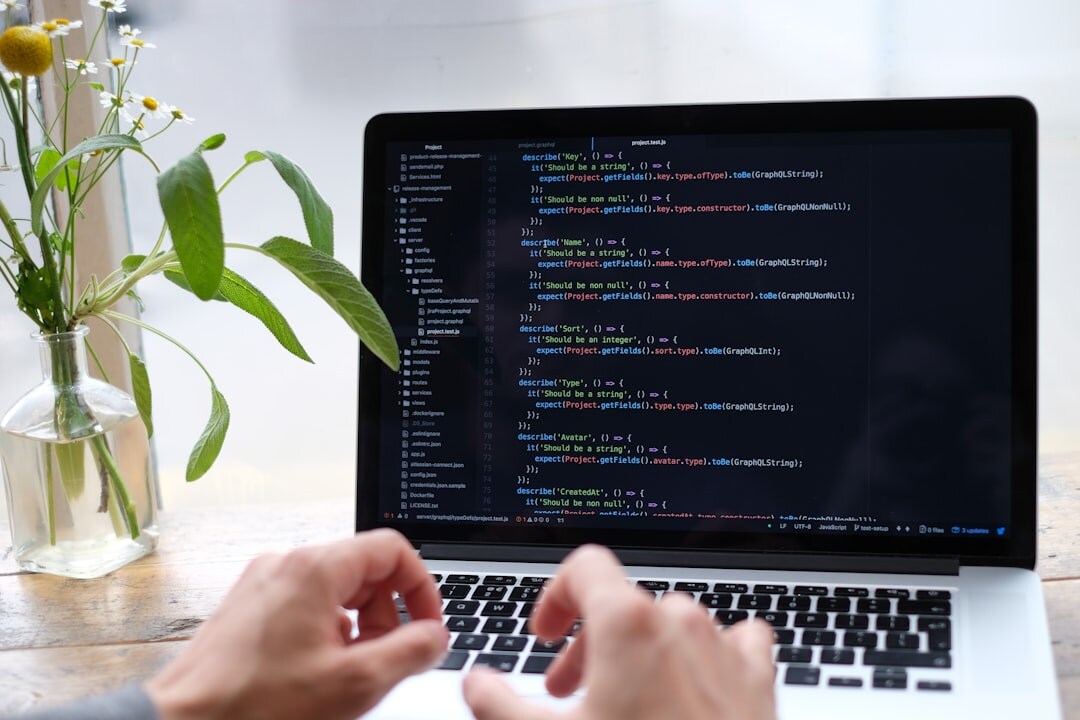 woman writing code on laptop
